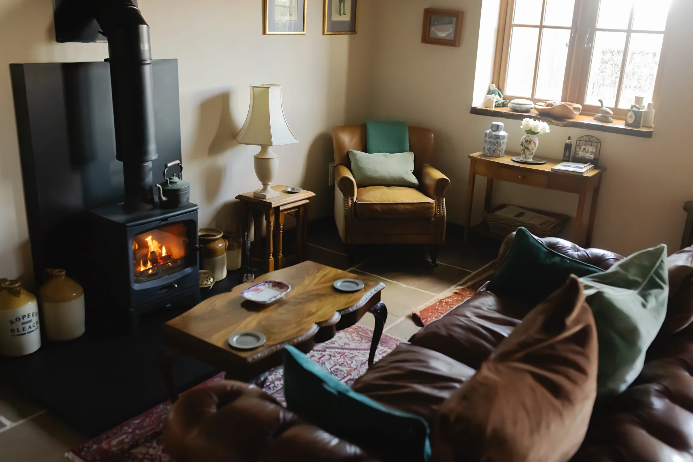 Wood burning stove and cosy seating area inside Gablebach cottage in the Welsh countryside