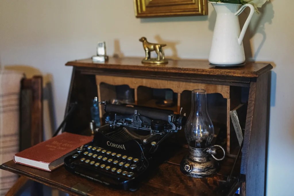 Vintage typewriter and antique furnishings inside Gablebach cottage in rural Wales