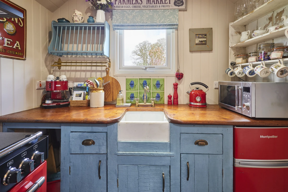 Characterful country kitchen at Y Golchdy with Belfast sink, wooden worktops and handcrafted details.