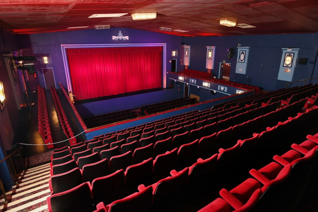 Interior of Brynamman Public Hall Cinema showing the vintage auditorium and traditional red theatre seating.