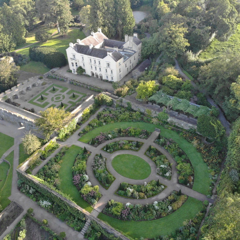 Aerial view of Aberglasney Gardens, showing the historic mansion, formal gardens and surrounding Carmarthenshire countryside.